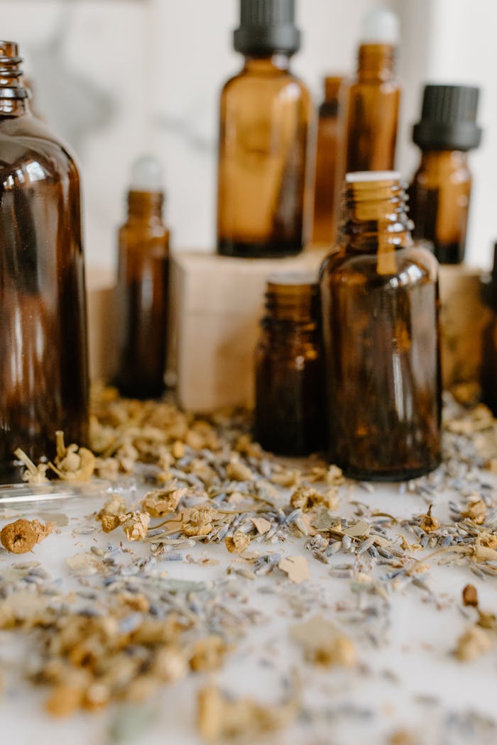 who-we-are Aromatic herbal essential oils with chamomile and lavender on a white surface.